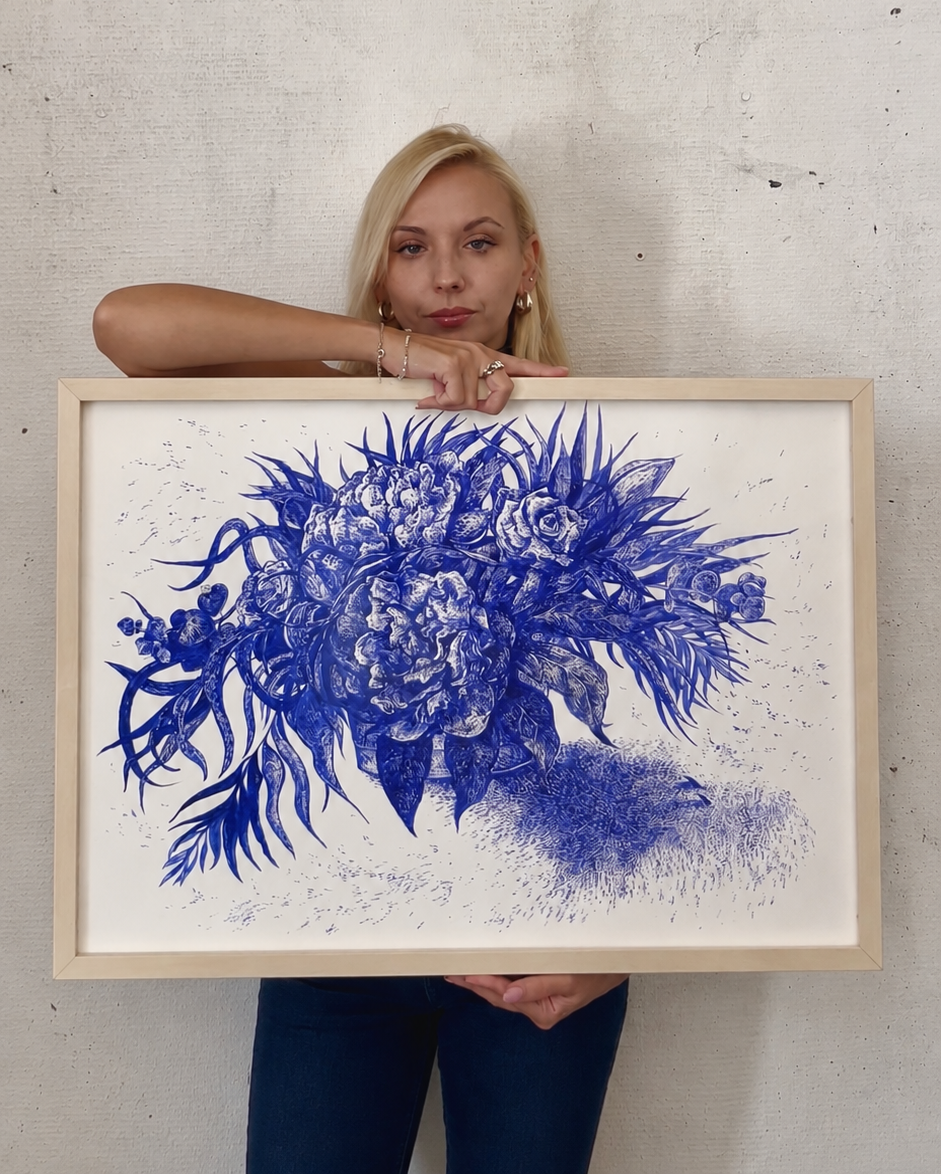 Portrait of the artist Marta Valkiv in front of a blue floral mural